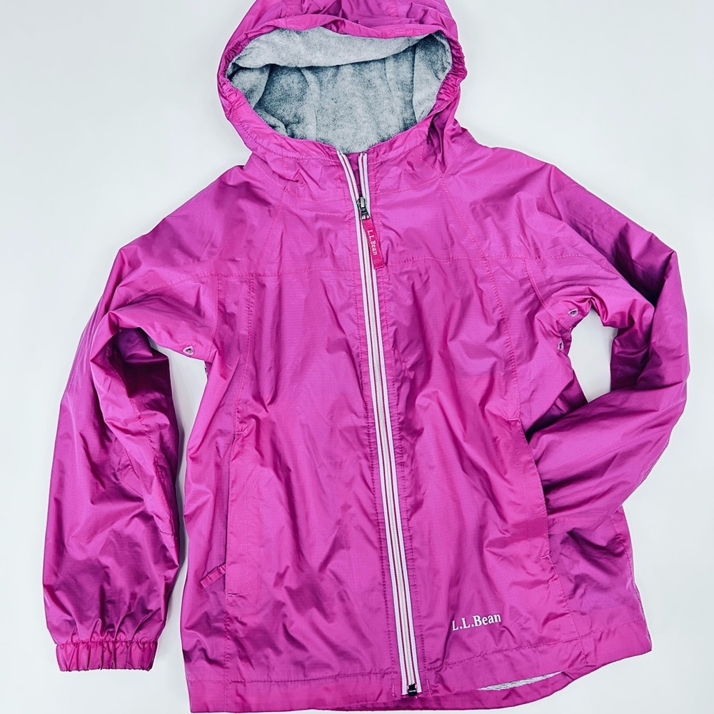 L.L. BEAN  Girls Lined Wind and Rain Jacket in a magenta or pink color.